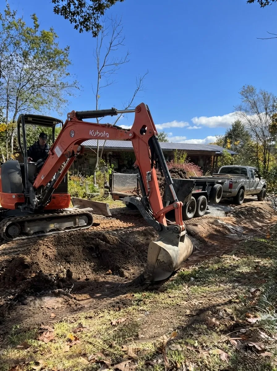 Double J excavator working on a cleared dirt job site in Winfield, Alabama