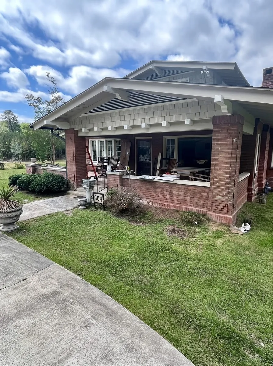 Brick porch covered in debris and clutter before cleanup